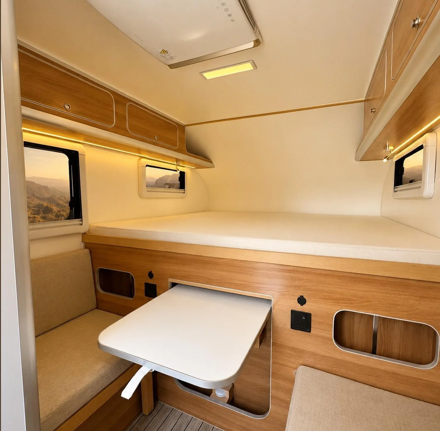 King-size sleeping platform and folding table inside the Leman ATLAS camper